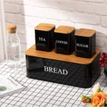 Upgrade your kitchen organization with the 4 PCS Set Bread Box with Sugar, Tea, Coffee Containers, designed to store bread, pastries, biscuits, and pantry essentials in an organized and stylish manner. This set features a bread box with a bamboo lid to keep your bread fresh, alongside three canisters for sugar, tea, and coffee. Its practical and elegant design makes it an excellent addition to your kitchen or dining area, offering both function and style. The bread box with bamboo lid provides a reliable solution for storing bread, keeping it fresh for longer. The containers for sugar, tea, and coffee are ideal for keeping your favorite ingredients within easy reach. The set comes in three beautiful colors—black, ivory, and red—to match various kitchen decors and styles. Whether you're storing your bread, tea, coffee, or sugar, this set ensures that your kitchen is neat, tidy, and well-organized. The 4-piece set bread box is made from high-quality materials that ensure durability, while the bamboo lid adds a touch of nature and elegance to the kitchen. Its spacious design also allows for easy access, making it convenient for daily use. Whether you are storing your bread, pastries, or dry foods, this set will keep your essentials safe and organized. KEY FEATURES: 4-PIECE SET: Includes a bread box with bamboo lid and containers for sugar, tea, and coffee. BAMBOO LID: Adds an eco-friendly and stylish touch to your kitchen while keeping bread fresh. MULTI-PURPOSE STORAGE: Ideal for storing bread, pastries, biscuits, and pantry essentials. DURABLE CONSTRUCTION: High-quality metal with a sturdy bamboo lid for long-lasting use. AVAILABLE COLORS: Choose from black, ivory, and red to match your kitchen decor. EASY ACCESS: Flip-top lids for easy and convenient access to your bread and pantry items. VERSATILE USE: Suitable for home kitchens, restaurants, cafes, and more. SPECIFICATIONS: Set Includes: 1 bread box with bamboo lid, 3 containers for sugar, tea, and coffee. Material: High-quality metal with a bamboo lid for the bread box. Storage Use: Perfect for storing bread, pastries, biscuits, sugar, tea, and coffee. Colors Available: Black, Ivory, Red. Dimensions: (Specify dimensions of each item). Cleaning: Easy to clean and maintain with a wipeable surface. For the best prices, fast delivery, and excellent customer service, Racks.lk is the ideal place to buy your 4 PCS Set Bread Box with Sugar, Tea, and Coffee Containers in Sri Lanka.