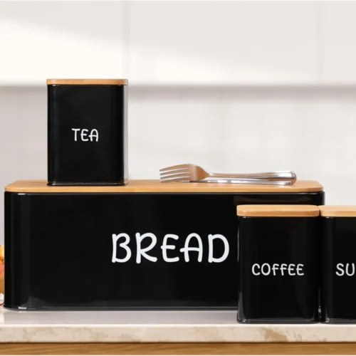 Upgrade your kitchen organization with the 4 PCS Set Bread Box with Sugar, Tea, Coffee Containers, designed to store bread, pastries, biscuits, and pantry essentials in an organized and stylish manner. This set features a bread box with a bamboo lid to keep your bread fresh, alongside three canisters for sugar, tea, and coffee. Its practical and elegant design makes it an excellent addition to your kitchen or dining area, offering both function and style. The bread box with bamboo lid provides a reliable solution for storing bread, keeping it fresh for longer. The containers for sugar, tea, and coffee are ideal for keeping your favorite ingredients within easy reach. The set comes in three beautiful colors—black, ivory, and red—to match various kitchen decors and styles. Whether you're storing your bread, tea, coffee, or sugar, this set ensures that your kitchen is neat, tidy, and well-organized. The 4-piece set bread box is made from high-quality materials that ensure durability, while the bamboo lid adds a touch of nature and elegance to the kitchen. Its spacious design also allows for easy access, making it convenient for daily use. Whether you are storing your bread, pastries, or dry foods, this set will keep your essentials safe and organized. KEY FEATURES: 4-PIECE SET: Includes a bread box with bamboo lid and containers for sugar, tea, and coffee. BAMBOO LID: Adds an eco-friendly and stylish touch to your kitchen while keeping bread fresh. MULTI-PURPOSE STORAGE: Ideal for storing bread, pastries, biscuits, and pantry essentials. DURABLE CONSTRUCTION: High-quality metal with a sturdy bamboo lid for long-lasting use. AVAILABLE COLORS: Choose from black, ivory, and red to match your kitchen decor. EASY ACCESS: Flip-top lids for easy and convenient access to your bread and pantry items. VERSATILE USE: Suitable for home kitchens, restaurants, cafes, and more. SPECIFICATIONS: Set Includes: 1 bread box with bamboo lid, 3 containers for sugar, tea, and coffee. Material: High-quality metal with a bamboo lid for the bread box. Storage Use: Perfect for storing bread, pastries, biscuits, sugar, tea, and coffee. Colors Available: Black, Ivory, Red. Dimensions: (Specify dimensions of each item). Cleaning: Easy to clean and maintain with a wipeable surface. For the best prices, fast delivery, and excellent customer service, Racks.lk is the ideal place to buy your 4 PCS Set Bread Box with Sugar, Tea, and Coffee Containers in Sri Lanka.