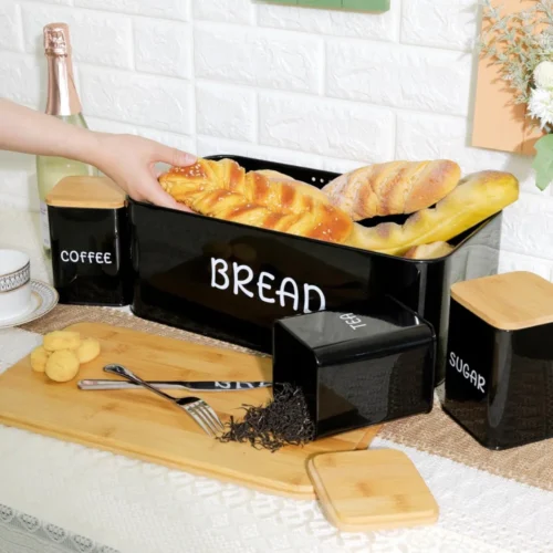 Upgrade your kitchen organization with the 4 PCS Set Bread Box with Sugar, Tea, Coffee Containers, designed to store bread, pastries, biscuits, and pantry essentials in an organized and stylish manner. This set features a bread box with a bamboo lid to keep your bread fresh, alongside three canisters for sugar, tea, and coffee. Its practical and elegant design makes it an excellent addition to your kitchen or dining area, offering both function and style. The bread box with bamboo lid provides a reliable solution for storing bread, keeping it fresh for longer. The containers for sugar, tea, and coffee are ideal for keeping your favorite ingredients within easy reach. The set comes in three beautiful colors—black, ivory, and red—to match various kitchen decors and styles. Whether you're storing your bread, tea, coffee, or sugar, this set ensures that your kitchen is neat, tidy, and well-organized. The 4-piece set bread box is made from high-quality materials that ensure durability, while the bamboo lid adds a touch of nature and elegance to the kitchen. Its spacious design also allows for easy access, making it convenient for daily use. Whether you are storing your bread, pastries, or dry foods, this set will keep your essentials safe and organized. KEY FEATURES: 4-PIECE SET: Includes a bread box with bamboo lid and containers for sugar, tea, and coffee. BAMBOO LID: Adds an eco-friendly and stylish touch to your kitchen while keeping bread fresh. MULTI-PURPOSE STORAGE: Ideal for storing bread, pastries, biscuits, and pantry essentials. DURABLE CONSTRUCTION: High-quality metal with a sturdy bamboo lid for long-lasting use. AVAILABLE COLORS: Choose from black, ivory, and red to match your kitchen decor. EASY ACCESS: Flip-top lids for easy and convenient access to your bread and pantry items. VERSATILE USE: Suitable for home kitchens, restaurants, cafes, and more. SPECIFICATIONS: Set Includes: 1 bread box with bamboo lid, 3 containers for sugar, tea, and coffee. Material: High-quality metal with a bamboo lid for the bread box. Storage Use: Perfect for storing bread, pastries, biscuits, sugar, tea, and coffee. Colors Available: Black, Ivory, Red. Dimensions: (Specify dimensions of each item). Cleaning: Easy to clean and maintain with a wipeable surface. For the best prices, fast delivery, and excellent customer service, Racks.lk is the ideal place to buy your 4 PCS Set Bread Box with Sugar, Tea, and Coffee Containers in Sri Lanka.